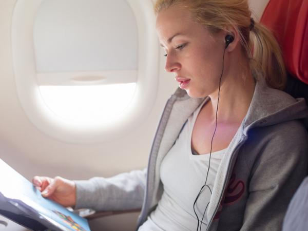 flight passenger reading inflight magazine